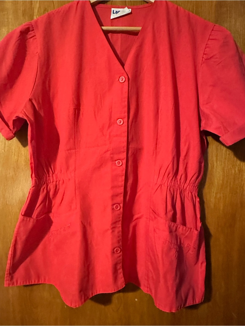 Landau Red 8234 women’s button up scrub top. This is not the bright red color